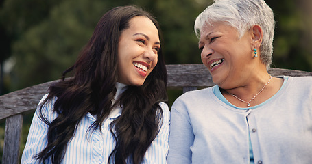 Image showing Happy, mature and mother with woman on bench, nature and bonding for laugh on retirement. Senior person, parent and older daughter for leisure together in park, care and love for funny joke in garden