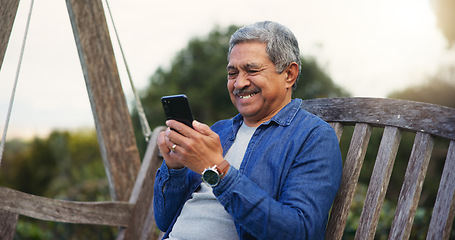 Image showing Senior man, happy and smartphone on bench for communication, connection and social media in park. Mature pensioner, smile and technology for lounge in nature, digital games and wellness on retirement