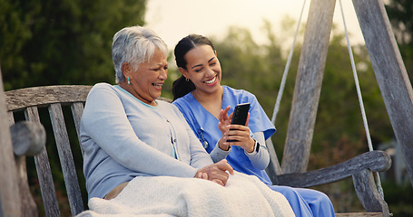 Image showing Outdoor, bench and nurse with senior woman, cellphone and connection with social media, conversation and internet. Pensioner, outdoor and caregiver with elderly person, smartphone and typing with app