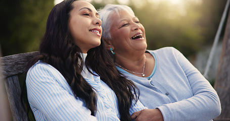 Image showing Happy, senior and mother with woman on bench, nature and bonding hug for laugh on retirement. Mature person, parent and older daughter for together in park, care and love with funny joke in garden