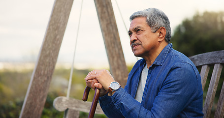 Image showing Senior, man or thinking with cane for retirement, alzheimer and memory outdoor on bench and lonely. Elderly, person or walking stick with nostalgia, thoughtful and peace in nature or park with wonder