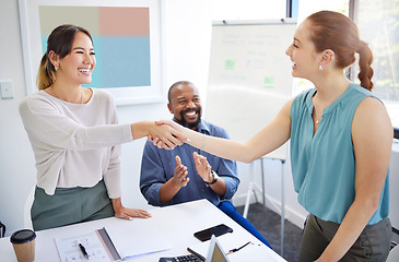 Image showing Business women, shaking hands and finance team in meeting for promotion, onboarding or welcome to company. Accountant, handshake or happy for congratulations, hiring or thank you with deal in group