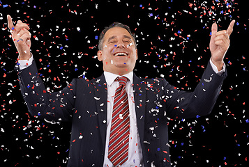 Image showing Business man,winner and confetti in success, celebration and winning, award or government election in studio. Professional person or politician in suit, achievement or competition on black background