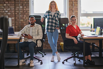 Image showing A diverse group of young business individuals congregates in a modern startup coworking center, embodying collaborative innovation and a dynamic atmosphere.