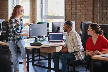 Image showing A diverse group of young business individuals congregates in a modern startup coworking center, embodying collaborative innovation and a dynamic atmosphere.