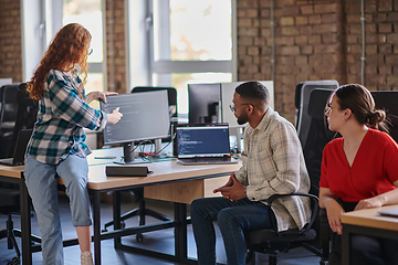 Image showing A diverse group of young business individuals congregates in a modern startup coworking center, embodying collaborative innovation and a dynamic atmosphere.