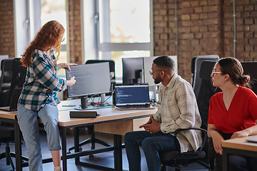 Image showing A diverse group of young business individuals congregates in a modern startup coworking center, embodying collaborative innovation and a dynamic atmosphere.