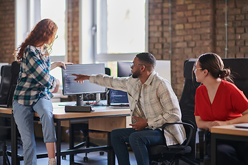 Image showing A diverse group of young business individuals congregates in a modern startup coworking center, embodying collaborative innovation and a dynamic atmosphere.