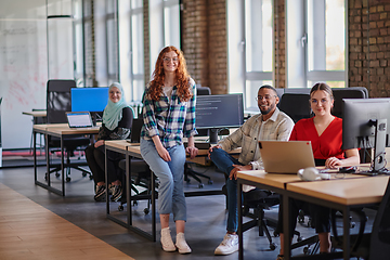 Image showing A diverse group of young business individuals congregates in a modern startup coworking center, embodying collaborative innovation and a dynamic atmosphere.