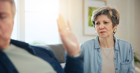 Image showing Senior, couple and divorce with conflict and fight on sofa in living room of home with hand for stop. Elderly, man and woman with argument, upset and frustrated on couch in lounge of house or ignore