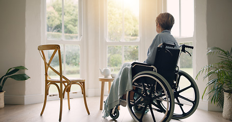 Image showing Wheelchair, old woman or thinking and lonely by window in nursing home or retirement with depression. Nostalgia, sad memory or depressed elderly person in lounge by an empty chair to remember past