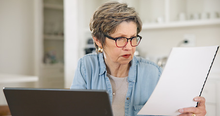 Image showing Senior woman, laptop and documents for finance, budget planning or expenses in living room at home. Mature female person busy with paperwork on computer for financial investment, bills or mortgage