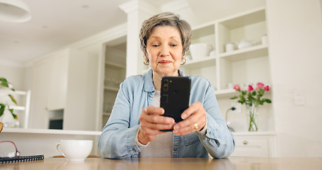 Image showing Senior woman typing on smartphone in home at table for social media, reading email or chat. Elderly person on mobile phone app, search internet and communication on digital technology in retirement