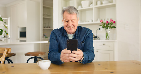 Image showing Happy senior man, phone and social media in relax for communication or networking in kitchen at home. Mature male person smile on mobile smartphone for online chatting, texting or search at house