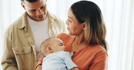 Image showing Family, love and parents with baby in home for bonding, healthy relationship and childcare. Happy, childhood and mother, father and newborn infant embrace, care and relax together for happiness