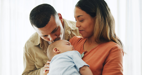 Image showing Family, love and parents kiss baby for bonding, healthy relationship and childcare in home. Happy, childhood and mother, father and newborn infant embrace, care and relax together for happiness