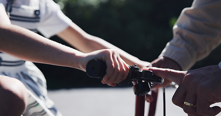 Image showing Parent, child and teaching bicycle ride for safety, closeup and outdoor street with hands. Cycling, childhood memory and riding in summer, bonding together and recreation with bike bell for alert