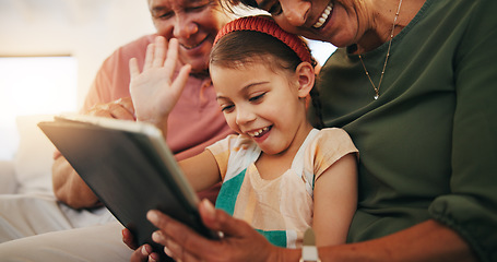 Image showing Tablet, video call and child with grandparents on sofa in the living room of modern family house. Happy, virtual communication and girl on digital technology relaxing with senior people at home.