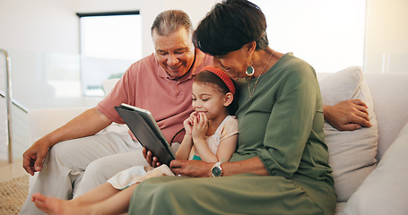 Image showing Tablet, elearning and child with grandparents on sofa in the living room of modern family house. Happy, online school and girl on digital technology relaxing with senior people in retirement at home.
