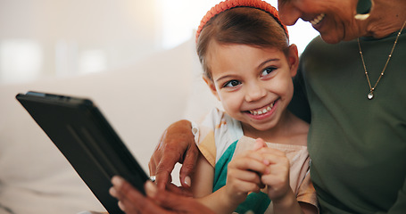 Image showing Tablet, learning and child with grandmother on sofa in living room of modern family house. Happy, online and girl on digital technology relaxing with senior female person in retirement at home.