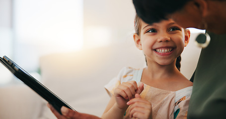 Image showing Home, grandmother on a sofa and girl with tablet, happy and relax with social media, internet and digital app. Apartment, senior woman and pensioner with grandchild, technology and online games