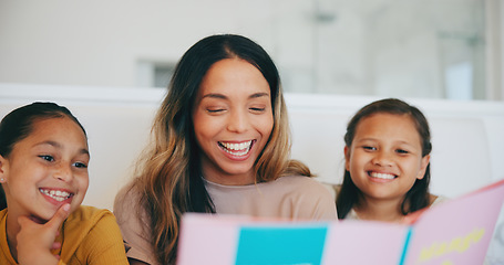 Image showing Happy, book and children reading with mom in living room and relaxing together at home. Smile, bonding and girl kids enjoying a story or fantasy novel with young mother in the lounge of modern house.