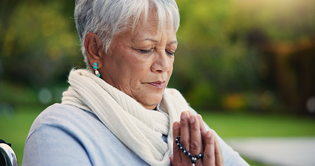 Image showing Senior woman, praying hands or rosary in wheelchair in nature, faith or hope in retirement. Mature person, catholic or meditation or praise to god, garden or petition as intercessor for jesus christ