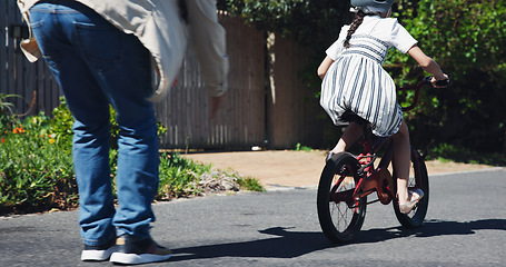 Image showing Dad, child and teaching bicycle ride for safety, outdoor street and having fun learning to cycle. Cycling, childhood memory and riding in summer with helmet, bonding together and recreation activity