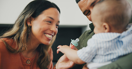 Image showing Family, smile and play or pacifier for love and bonding or fun, relax and support or laughing at home. Happy parents and baby, connect and humor or funny, joy and relaxed or silly, goofy and dummy