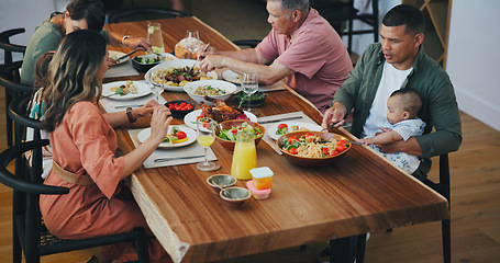 Image showing Family home, lunch and thanksgiving food on table with kids, plate and baby for festive celebration. Men, women and children in dining room, house and together at event, party and holiday brunch