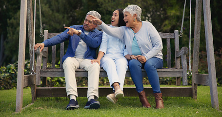 Image showing Father, senior or mother with woman on bench in nature pointing, talking or speaking in retirement. Dad, mature parents or daughter in conversation with bond together in park or garden as a family