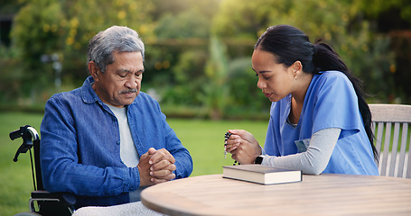 Image showing Wheelchair, praying or nurse with senior man for care, support or trust in retirement or nature. Caregiver, help and person or elderly patient with a disability or medical professional for worship