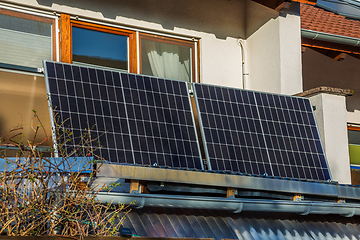 Image showing Balcony solar power plant. Solar battery on balcony wall. Mini PV plants generate your own electricity plug play.