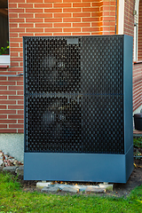 Image showing Air source heat pump installed outside in a garden
