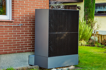 Image showing Air source heat pump installed outside in a garden