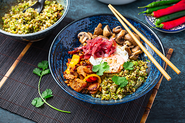 Image showing Ketogenic diet bowl with organic cauliflower and broccoli rice, stir fried chicken, mushrooms, egg and onions