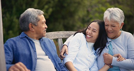 Image showing Senior, parents and woman in garden with hug, support and love in backyard and retirement. Happy family, elderly father and mother embrace daughter on bench in summer, park or bonding on vacation