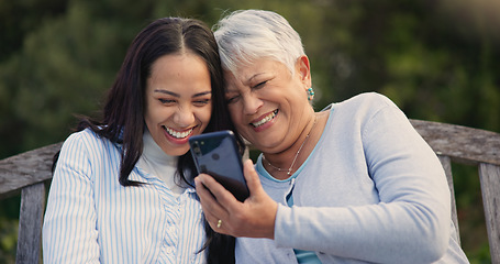 Image showing Senior, mother and woman with smartphone on bench, nature and laughing for social media meme on retirement. Mature parent, older daughter and technology in park for online comedy and love in garden