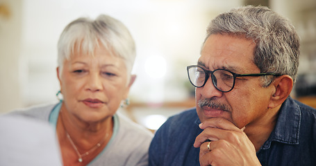 Image showing Senior couple, bills and reading documents in home for budget, planning financial assets and investment. Face of man, woman and thinking of paperwork, taxes or retirement savings for insurance policy