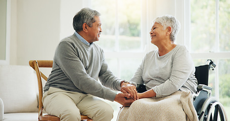 Image showing Love, retirement and an old woman in a wheelchair with her husband in the living room of their home together. Trust, support and an elderly man talking to his wife with a disability in the apartment