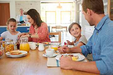 Image showing Food, breakfast and weekend with a family in the dining room of their home together for health or nutrition. Mother, father and children in the morning, eating at their apartment table for bonding