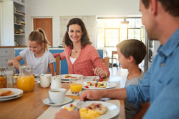 Image showing Smile, food and morning with a family in the dining room of their home together for health or nutrition. Mother, father and happy sibling kids eating breakfast at a table in an apartment for bonding