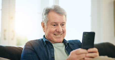 Image showing Happy senior man, phone and relax on sofa for communication, good news or networking at home. Mature male person smile on mobile smartphone for online chatting, texting or search on couch at house