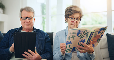 Image showing Senior couple, reading book and tablet on sofa in home, relax and internet search on social media. Elderly man, woman and technology, knowledge and information in living room in retirement together