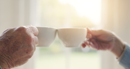 Image showing Elderly couple, hands or tea toast in house to enjoy bonding, love or celebration together in retirement. People, coffee drink or man at nursing home to relax with a senior woman on break by window