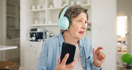 Image showing Mobile, headphones or old woman listening to radio playlist to relax in house to enjoy retirement. Home, freedom or senior person on break dancing, singing or streaming music, song or audio alone