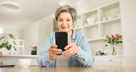 Image showing Happy senior woman, phone and social media in relax for communication or networking in kitchen at home. Mature female person smile on mobile smartphone for online chatting, texting or search at house