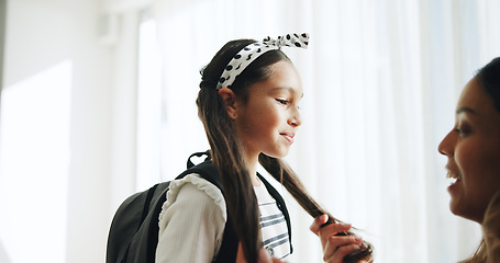 Image showing Happy, conversation and child with mother for school getting ready in the morning in living room. Smile, discussion and young mom helping a girl kid student with hairstyle for education at home.