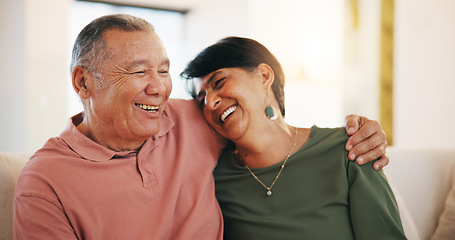 Image showing Happy couple, together and embrace on sofa in living room with laugh for funny joke, conversation or talk. Senior man, woman and hug for love, care or support with marriage, bond and communication