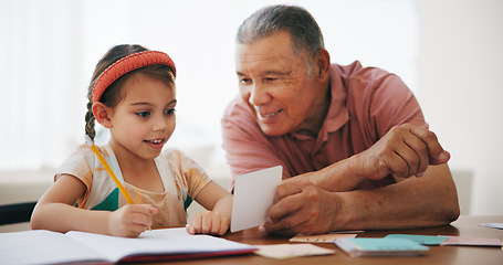 Image showing Child, senior man and learning or reading, book and education at home, drawing and support or paper. Girl, grandfather and notebook or tutoring, assessment and smile for language or math homework
